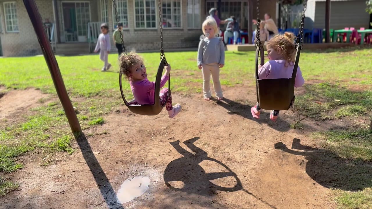 Children on the playground swings at Little Lion Pre-School